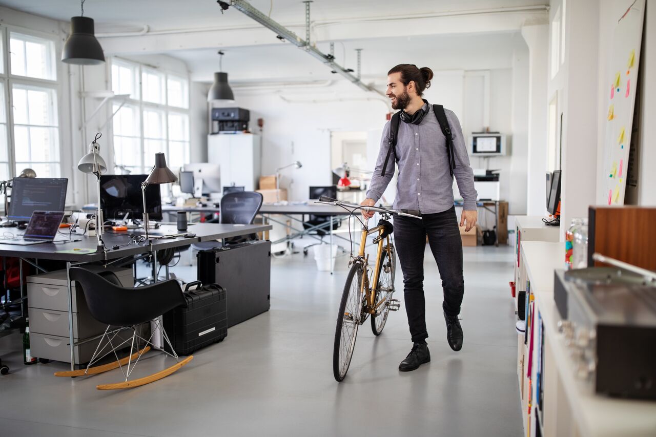 Business professional with bike inside the office